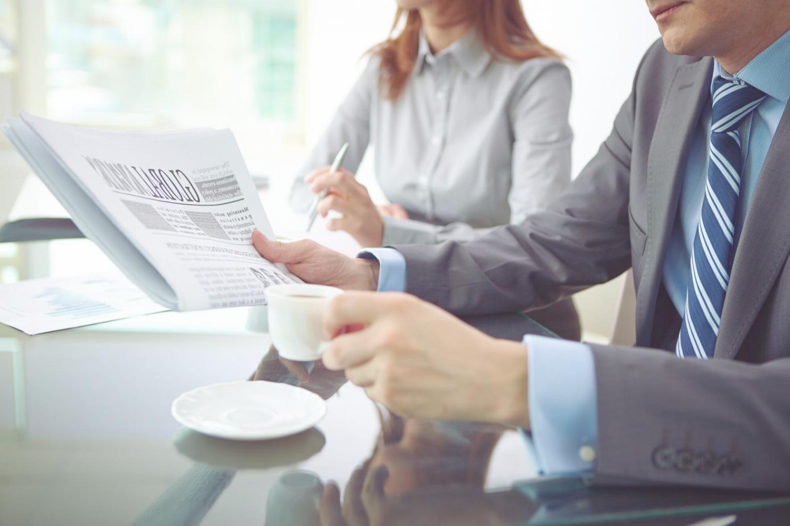 Business professional analyzing financial reports with charts and graphs