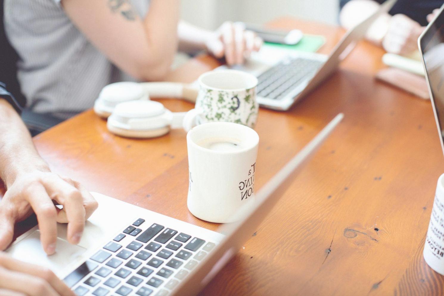 Students collaborating on financial analysis projects in modern learning environment